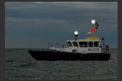 A vessel engaged in pilotage duties at anchor