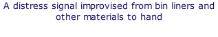 A distress signal improvised from bin liners and other materials to hand