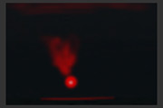 Red rocket flare falling into the sea