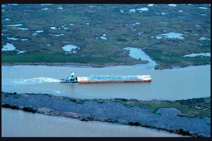 A vessel pushing a barge ahead - rigidly connected together in a composite unit