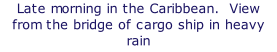 Late morning in the Caribbean.  View from the bridge of cargo ship in heavy rain