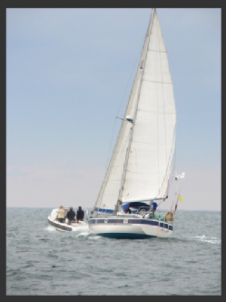 A sailing vessel overtaking a small power boat
