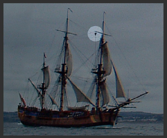 Large sailing vessel under sail and power, exhibiting a cone point downwards